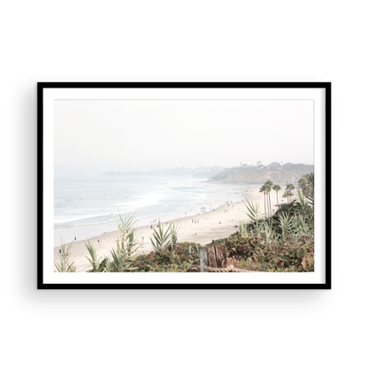 Landscape San Diego beach print showing seascape with gentle ocean waves in the water near a sandy cliff. Photograph in minimalist mock up.