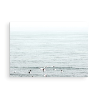 Horizontal surf art showing multiple surfers waiting in the calm ocean water for waves, with a hazy Southern California coastline in the distance. This minimalist surf print captures authentic surf vibes. Photograph in minimalist mock up.