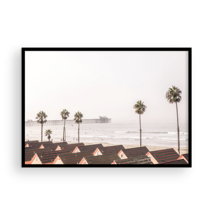 Landscape coastal photography of Oceanside, California, featuring a row of charming beachfront houses with the Oceanside Pier and ocean in the background.  Photograph in minimalist mock up.