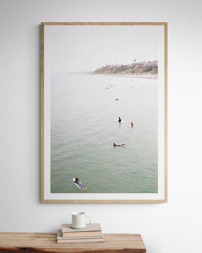 Vertical surf print of surfers floating in the ocean waves at a Southern California beach, with a distant coastline. This image captures surfing art and a minimalist surf vibe. Photograph in minimalist mock up.