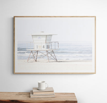 A horizontal beach art close-up of a pale lifeguard tower (14), with ocean waves in the distance, on a San Diego Beach. Photograph in minimalist mock up.