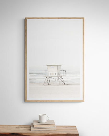 A vertical beach art close-up of a pale lifeguard tower (14), with ocean waves in the distance, on a San Diego Beach. Photograph in minimalist mock up.