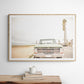 Nostalgic Southern California beach art featuring a classic light green Ford F-Series pickup truck parked by the San Diego coast. This horizontal surf print captures the vintage vehicle with a backdrop of iconic tall palm trees, a hazy beach, and the ocean, embodying surf vibes and perfect for coastal farmhouse decor. Photograph in minimalist framed mock up.