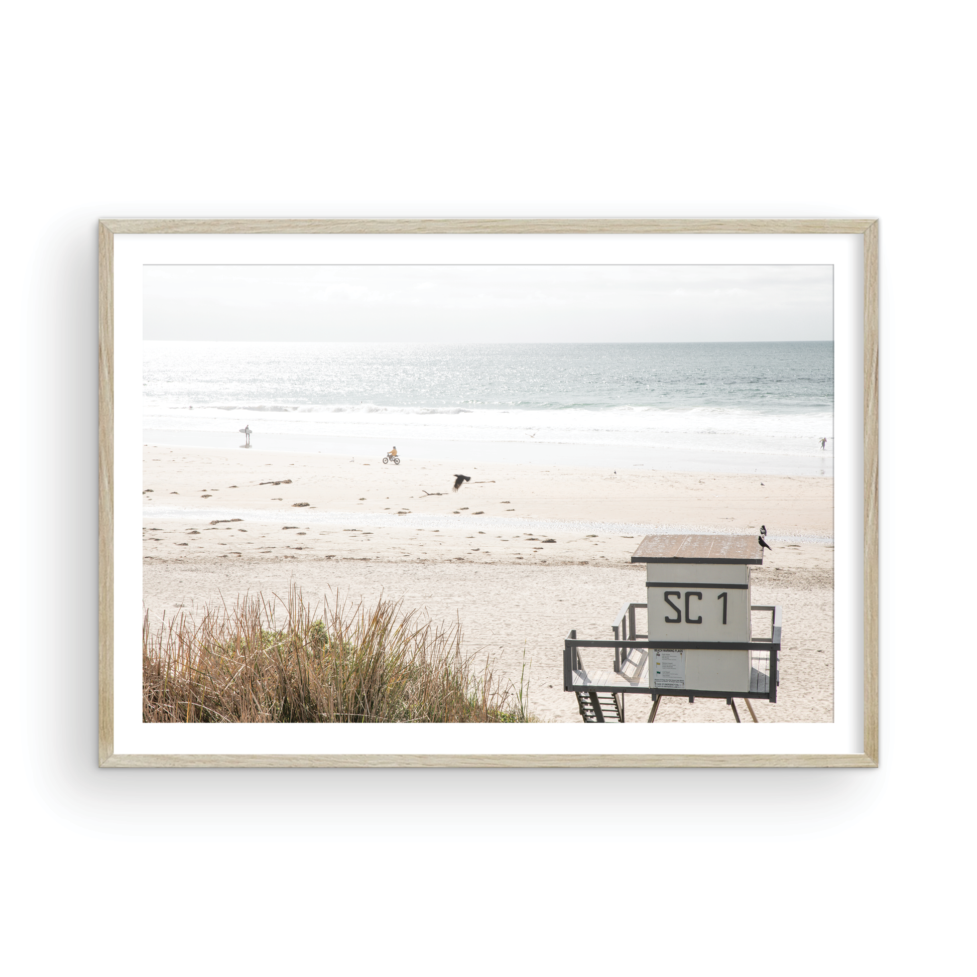 Landscape coastal photography of Salt Creek Beach Park featuring a lifeguard tower (SC 1) on the sand, with distant figures and ocean waves. This beachscape print has a calming vibe. Photograph in minimalist mock up.
