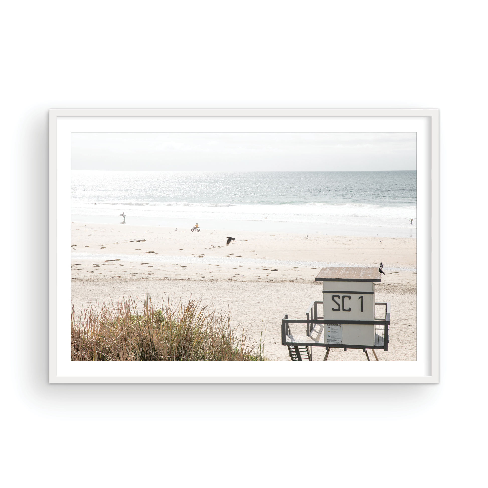 Landscape coastal photography of Salt Creek Beach Park featuring a lifeguard tower (SC 1) on the sand, with distant figures and ocean waves. This beachscape print has a calming vibe. Photograph in minimalist mock up.