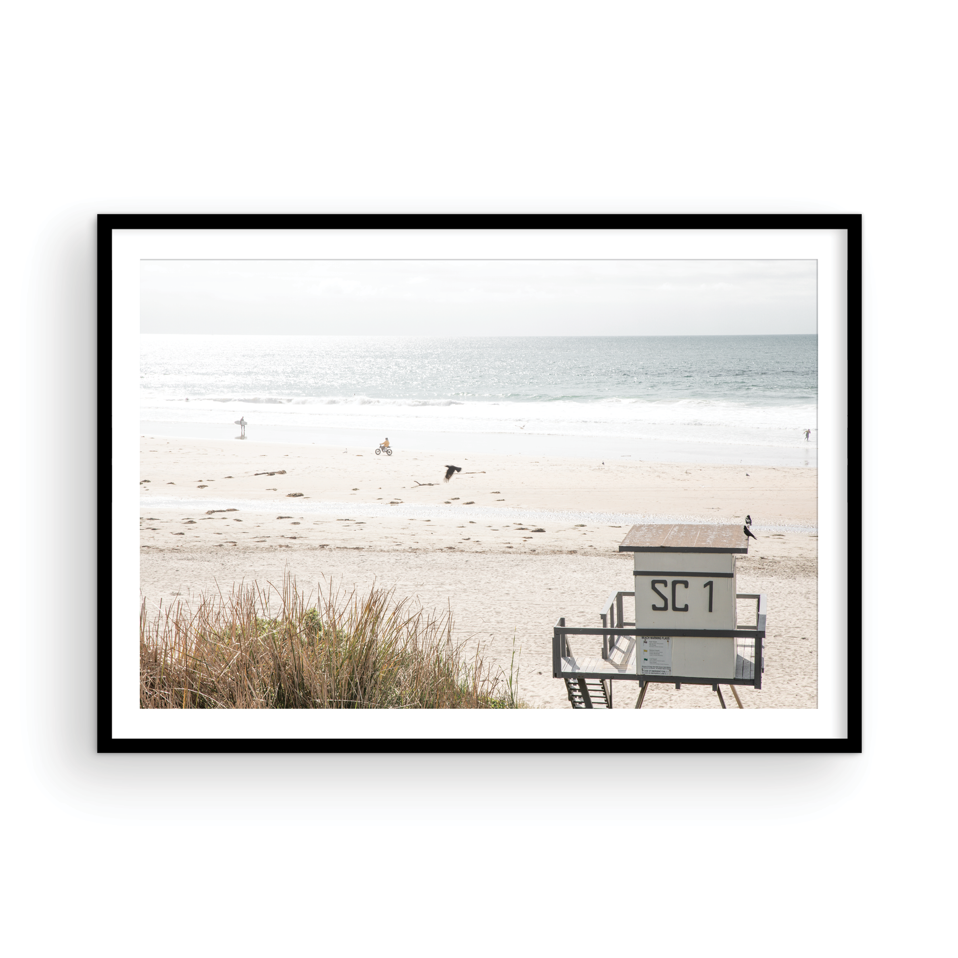 Landscape coastal photography of Salt Creek Beach Park featuring a lifeguard tower (SC 1) on the sand, with distant figures and ocean waves. This beachscape print has a calming vibe. Photograph in minimalist mock up.