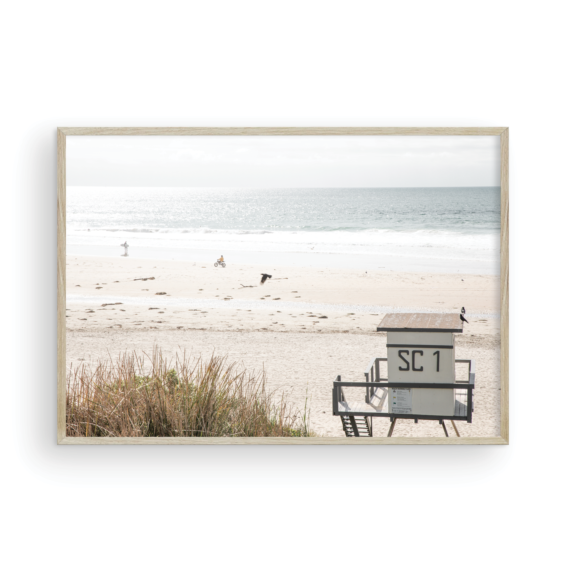 Landscape coastal photography of Salt Creek Beach Park featuring a lifeguard tower (SC 1) on the sand, with distant figures and ocean waves. This beachscape print has a calming vibe. Photograph in minimalist mock up.