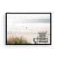Landscape coastal photography of Salt Creek Beach Park featuring a lifeguard tower (SC 1) on the sand, with distant figures and ocean waves. This beachscape print has a calming vibe. Photograph in minimalist mock up.