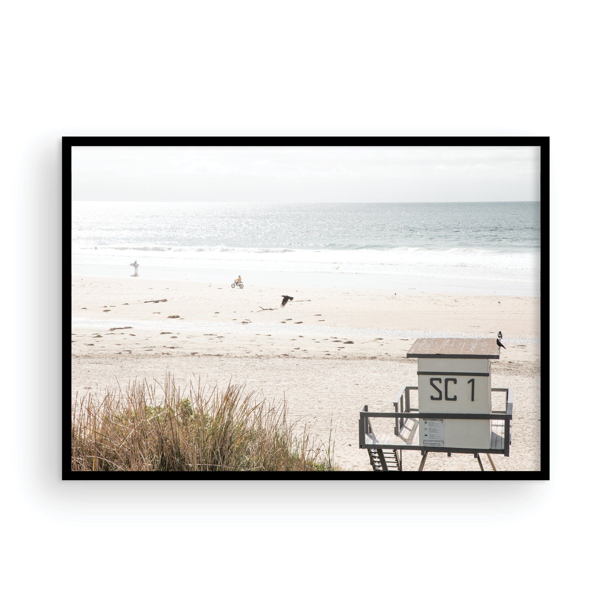 Landscape coastal photography of Salt Creek Beach Park featuring a lifeguard tower (SC 1) on the sand, with distant figures and ocean waves. This beachscape print has a calming vibe. Photograph in minimalist mock up.