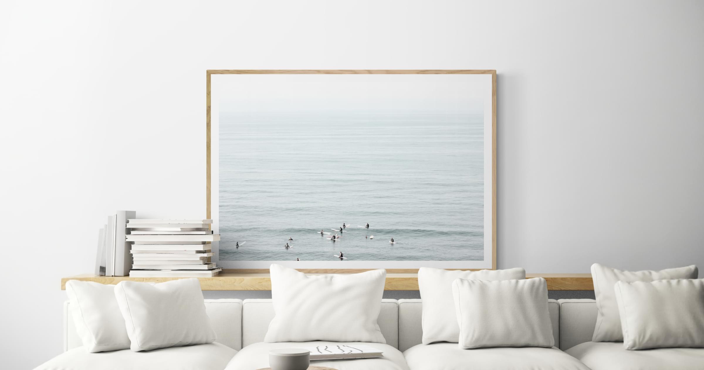 Modern living room with framed fine art photo of surfers in Encinitas, California.