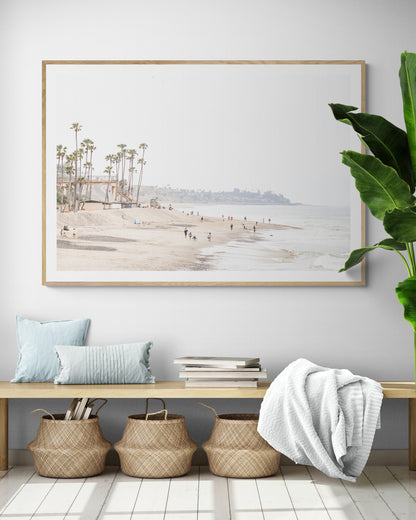 Landscape coastal photography of a wide sandy beach at San Clemente State Beach, with tall palm trees and people enjoying the calm ocean. Perfect for a beach theme wall decor. Photograph in minimalist mock up.