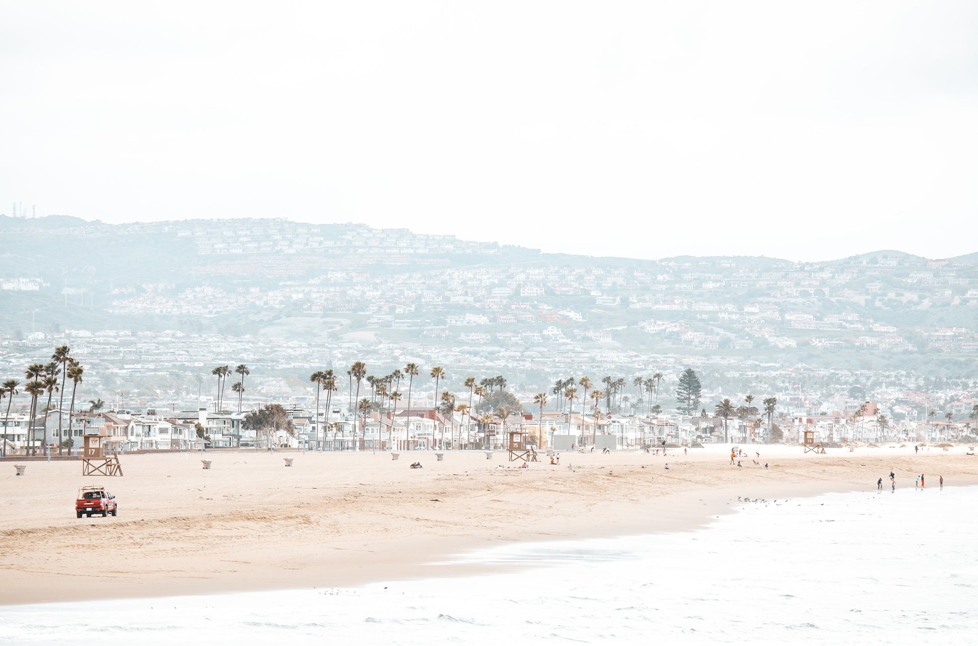 Photography by Kim Dybczak of: California lifeguard tower stands near the shoreline, framed by sand and quiet surf.