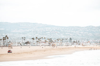 Photography by Kim Dybczak of: California lifeguard tower stands near the shoreline, framed by sand and quiet surf.