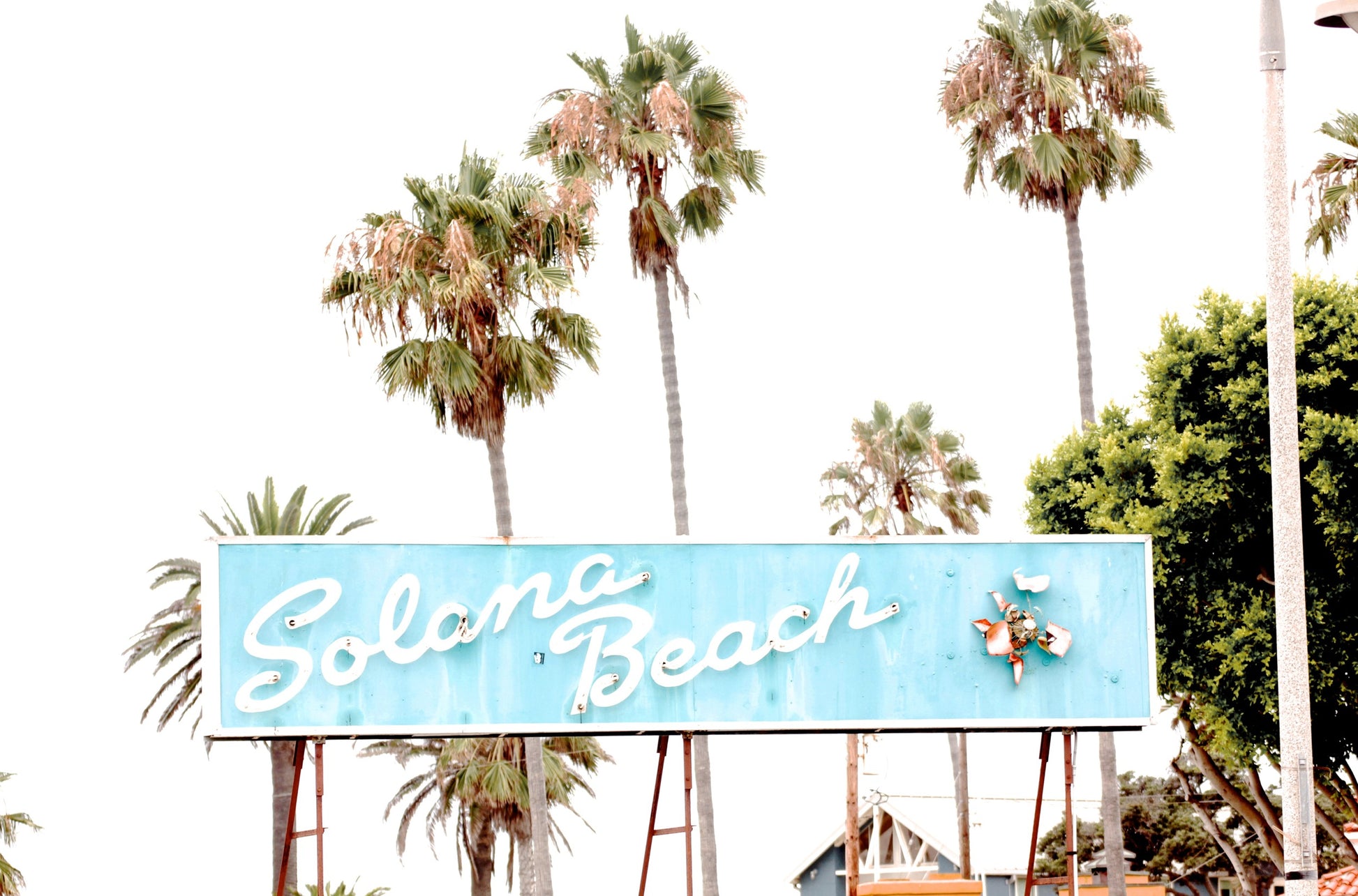 Photography by Kim Dybczak of: Retro Solana Beach sign in light blue, captured as colorful travel photography.