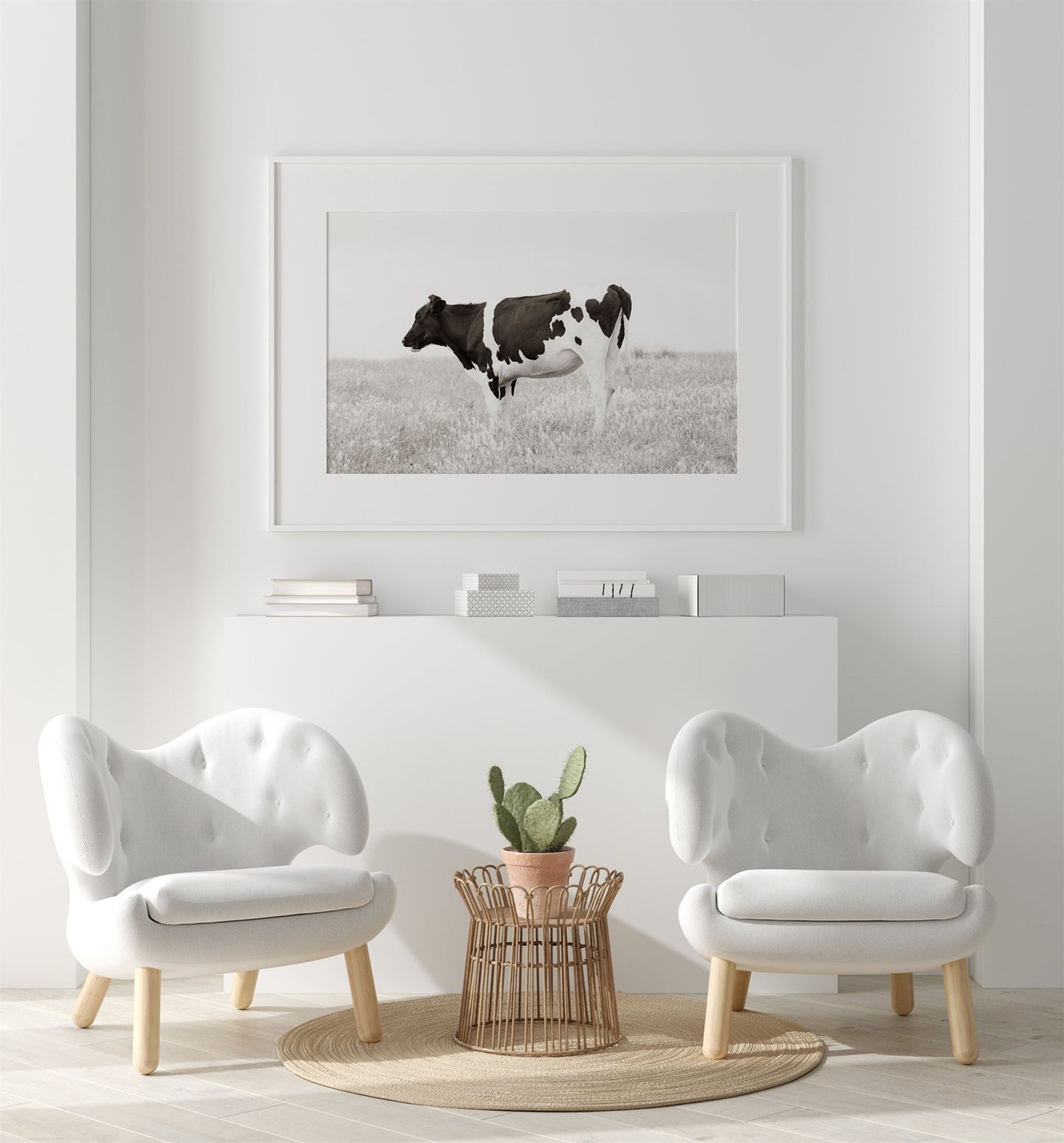 Framed photo of: Cow 7197 displayed on a wall in a sitting area of a white modern room. 