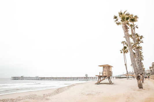 Photography by Kim Dybczak of: People crowd San Clemente State Beach, spreading from the sand into the breaking surf.