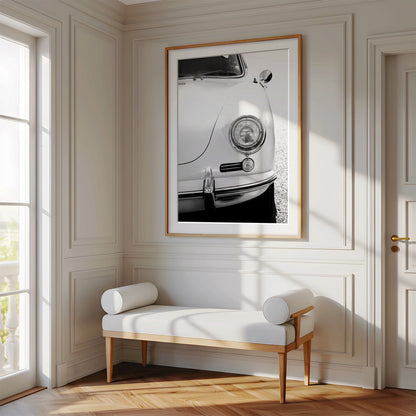 Framed photo of: Porsche 8259 displayed above a bench in a luxury hallway. 