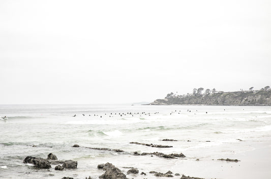 Photography by Kim Dybczak of: Surfers wait beyond the break at Salt Creek, watching sets roll in toward shore.
