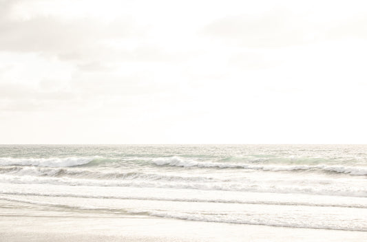 Photography by Kim Dybczak of: San Diego coast settles into long bands of sand and water beneath open sky.