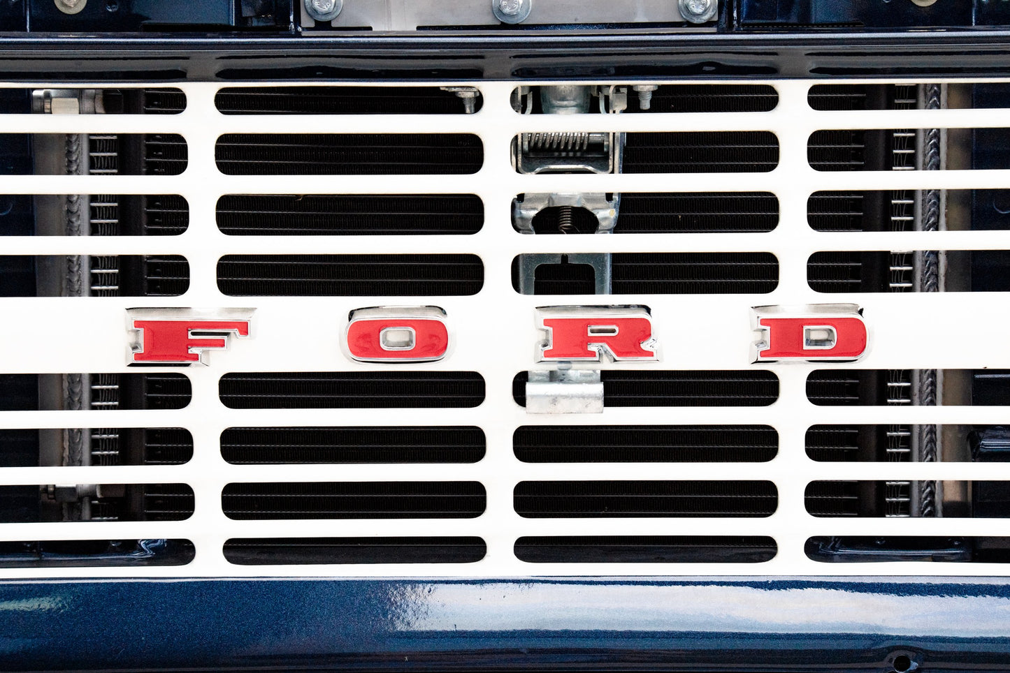 Photography by Salt Creek Prints of: Ford 8030, Close up image of the front grill of a vintage ford F-Series pickup.
