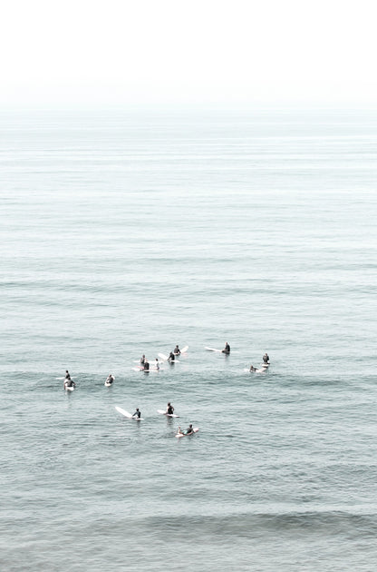 Photography by Kim Dybczak of: Surfers wait beyond the break at California, watching sets roll in toward shore.