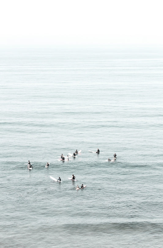 Photography by Kim Dybczak of: Surfers wait beyond the break at California, watching sets roll in toward shore.