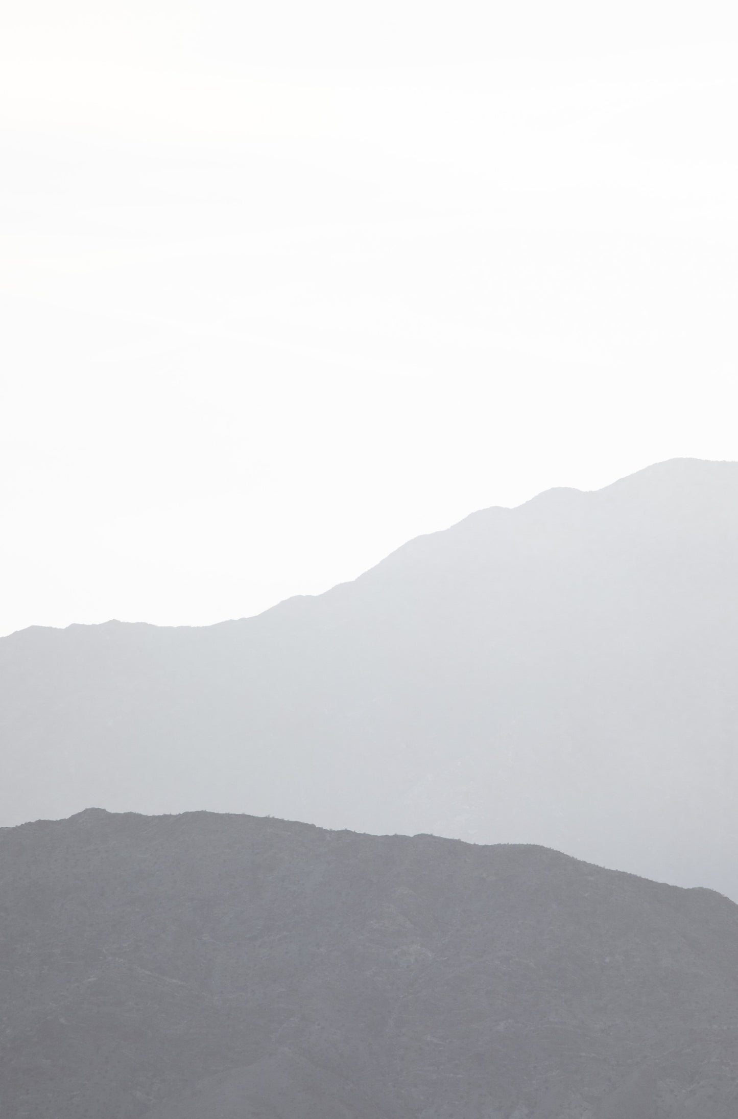 Photography by Kim Dybczak of: Hazy mountain layers fade into soft tones in Palm Springs, California.