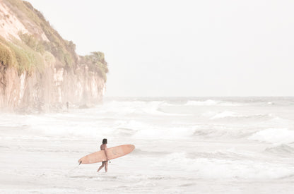 Photography by Kim Dybczak of: Surfers gather offshore, spaced out on the calm lineup, softened by coastal haze.
