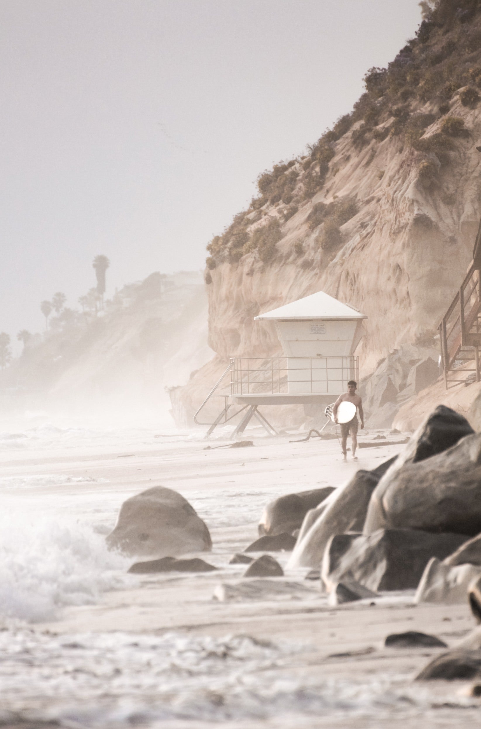 Photography by Kim Dybczak of: A California lifeguard tower set against calm water and open sky, softened by coastal haze.