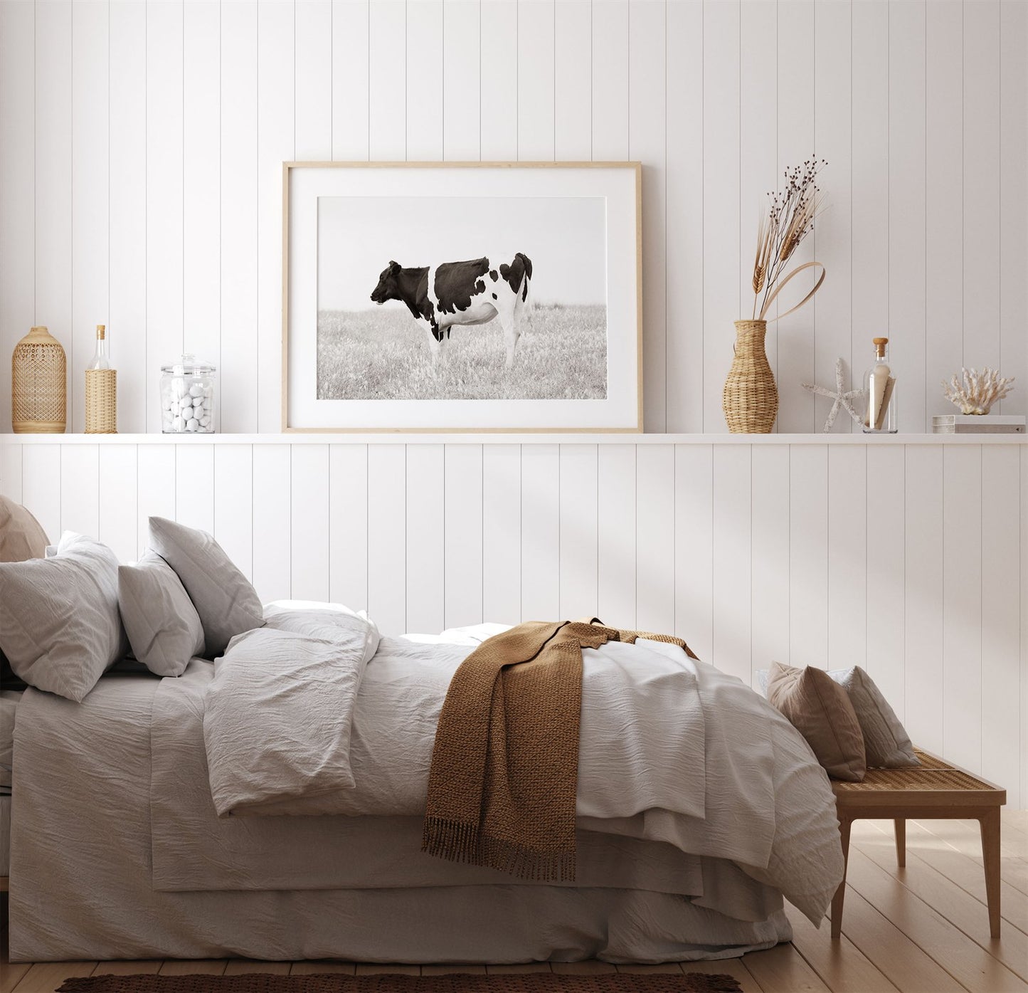 Framed photo of: Cow 7197 above a bed in a farmhouse bedroom.