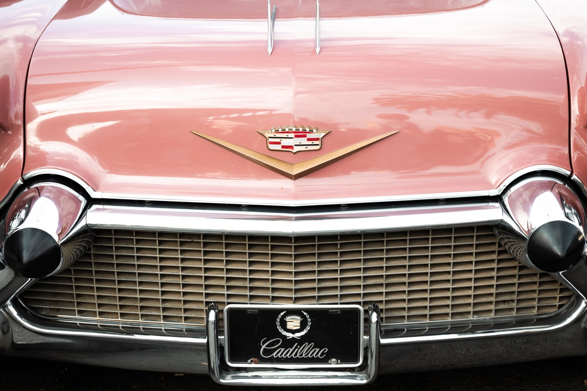 Photography by Salt Creek Prints of: Cadillac 7917, Close up image of the back of a vintage classic Cadillac in rosy pink.