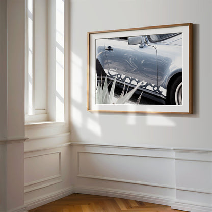 Framed photo of: Porsche Carrera 8334 displayed on a wall in a luxury hallway.
