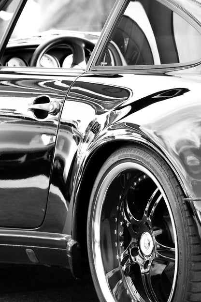 Photography by Salt Creek Prints of: Porsche 8346, Close up black and white image of the side of a modern sleek Porsche.