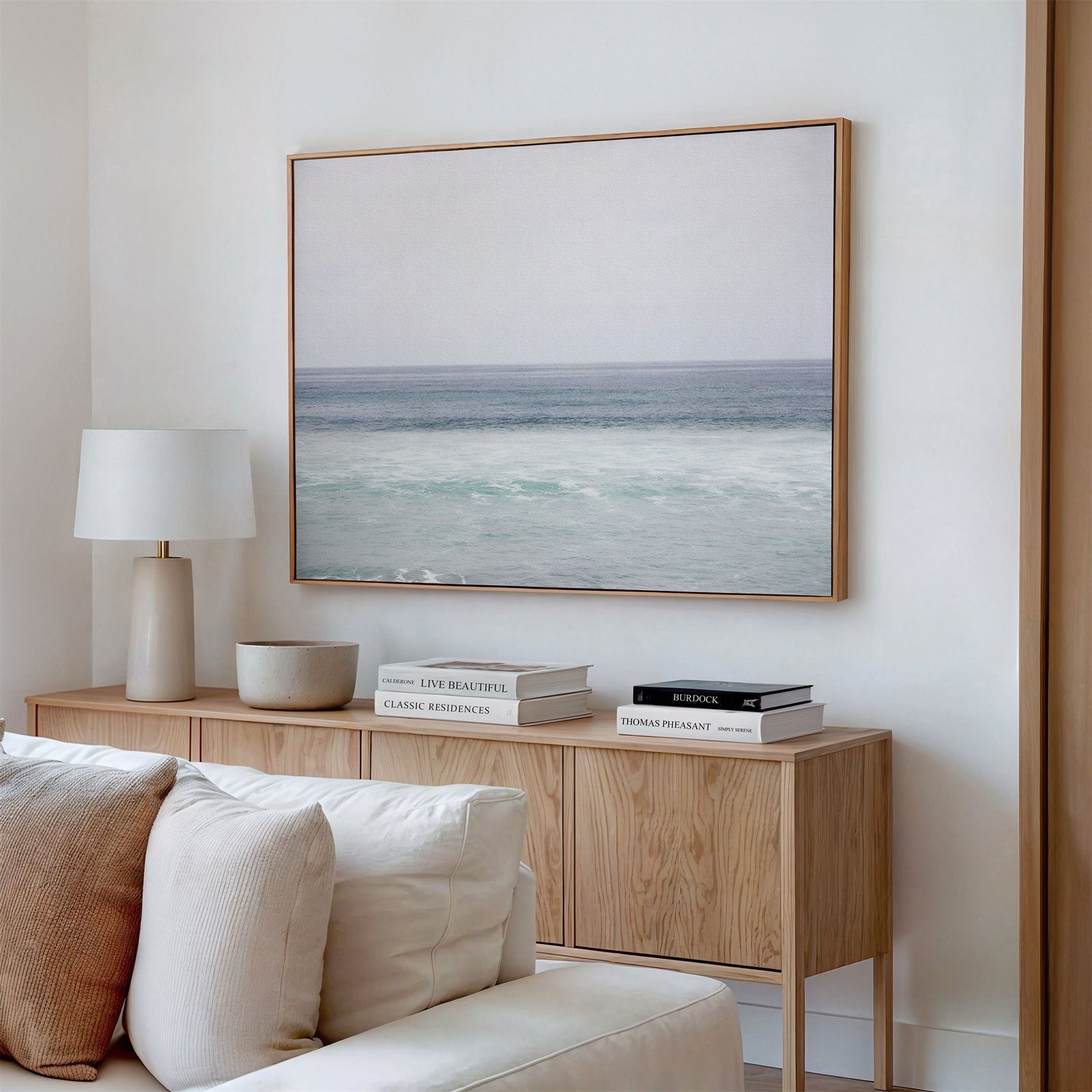 Framed photo of: Torrey Pines 8653 displayed above a console in a neutral modern living room.