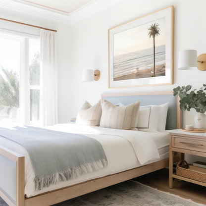 Framed photo of: Moonlight Beach 9130 displayed above a bed in a coastal bedroom.