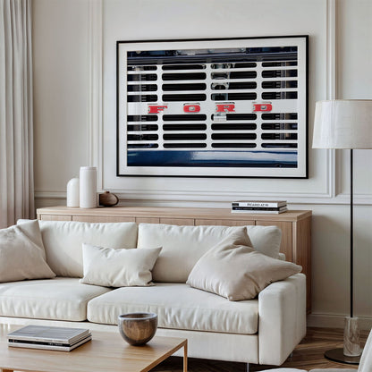 Framed photo of: Ford 8030 displayed on a wall above a couch in a neutral living room.