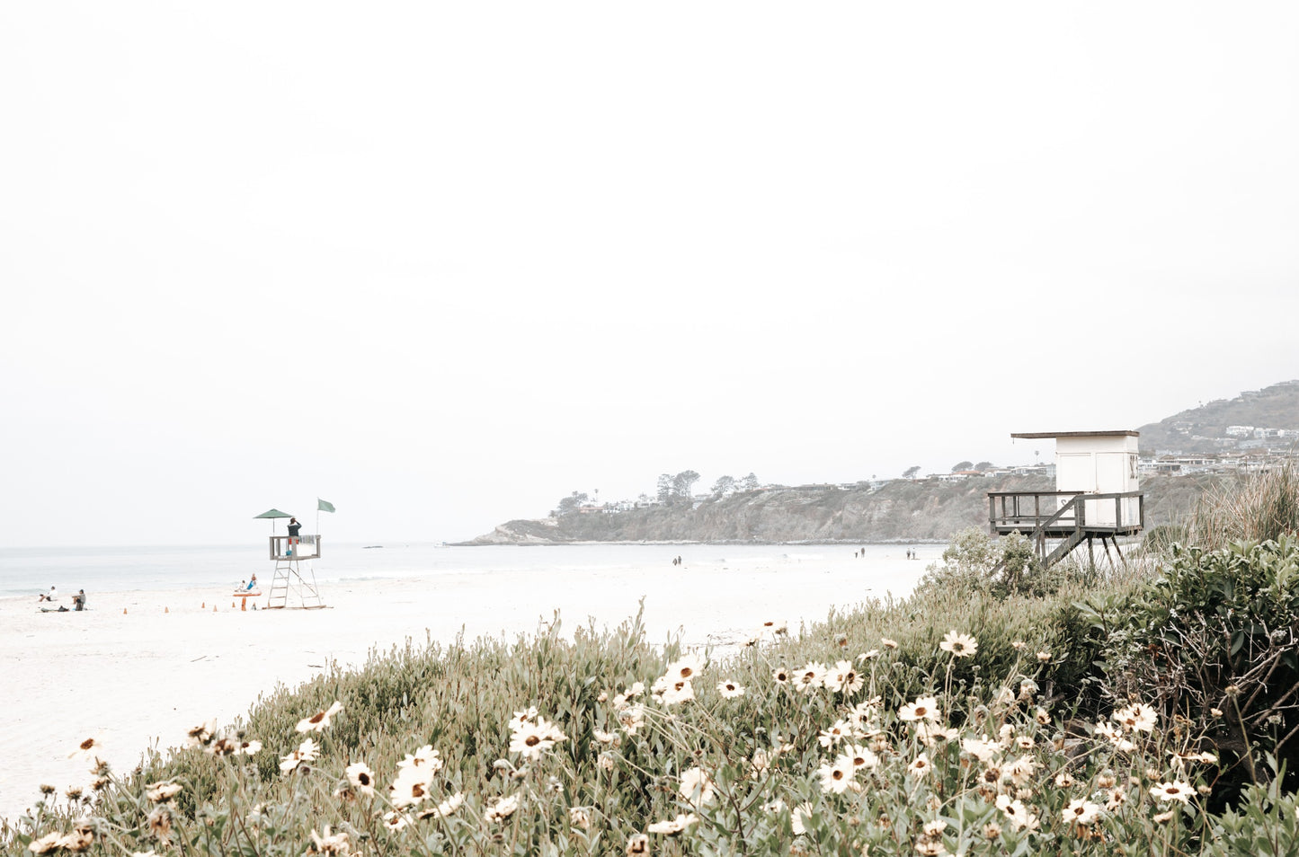 Photography by Kim Dybczak of: A simple lifeguard tower stands on the sand at Salt Creek, with gentle waves behind it.