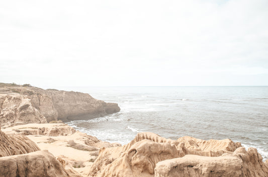 Photography by Kim Dybczak of: Rugged Sunset Cliffs drop toward the Pacific, shaping a dramatic coastline in evening light.