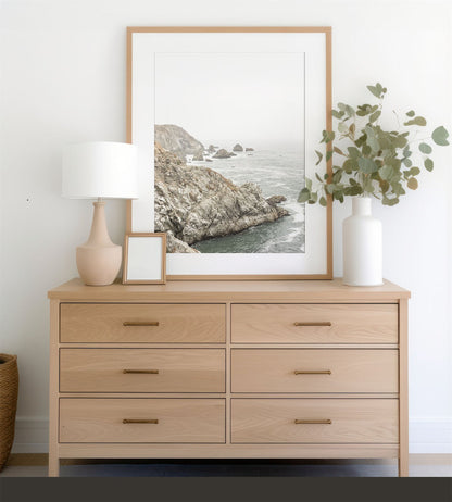 Framed photo of: Bodega Head 7724 displayed above a dresser.