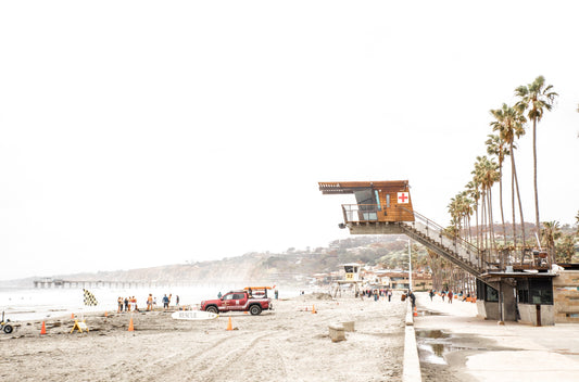 Photography by Kim Dybczak of: The coast cliffs rise above the shoreline, meeting open ocean below.