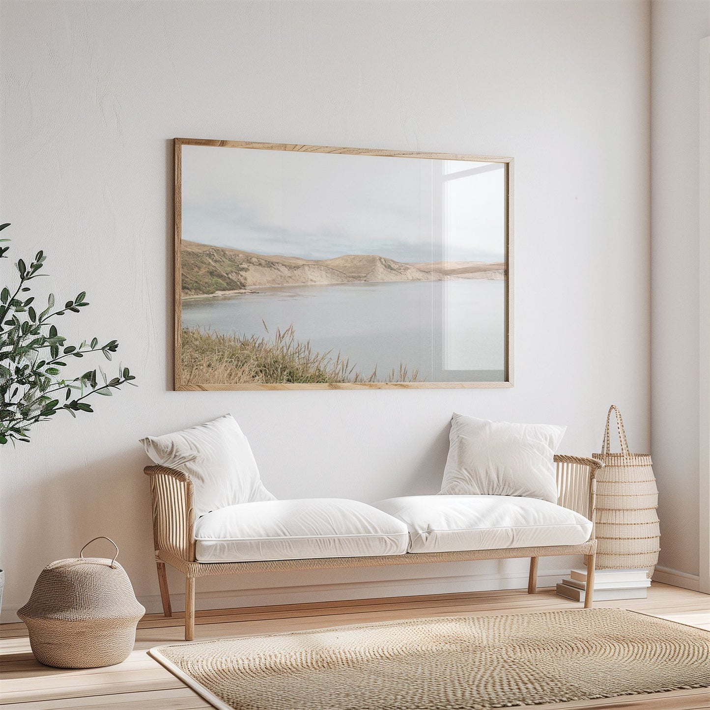 Framed photo of: Drakes Bay 7383 displayed above a couch in a neutral room.