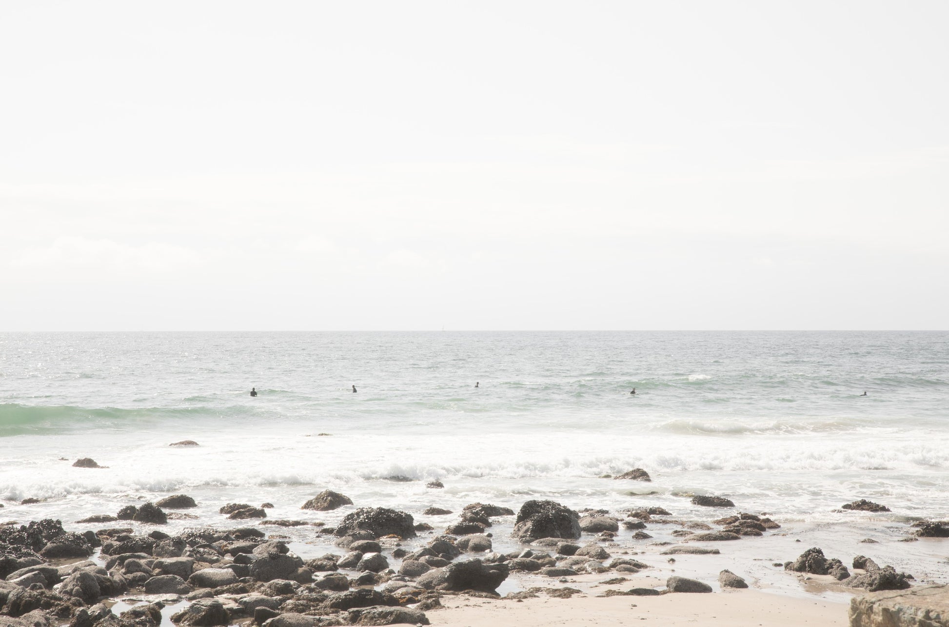 Photography by Kim Dybczak of: Surfers wait beyond the break at Salt Creek, watching sets roll in toward shore.