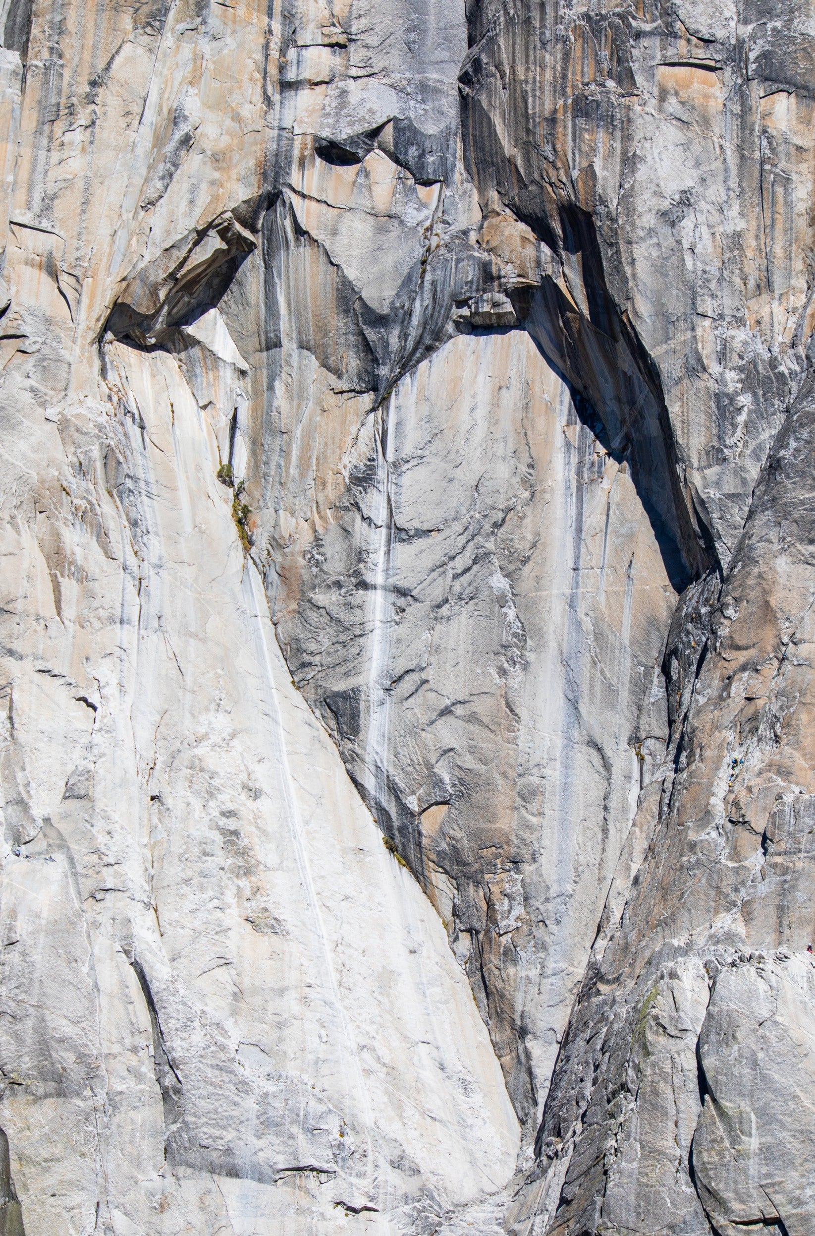 Photography by Kim Dybczak of: California cliffs rise above the shoreline, meeting open ocean below.