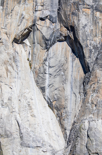 Photography by Kim Dybczak of: California cliffs rise above the shoreline, meeting open ocean below.