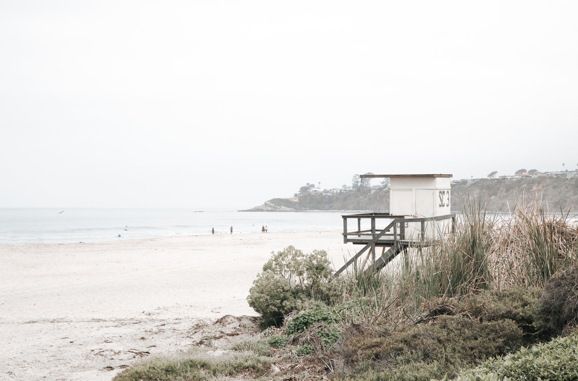 Photography by Kim Dybczak of: People crowd a Salt Creek beach, spreading from the sand into the breaking surf.