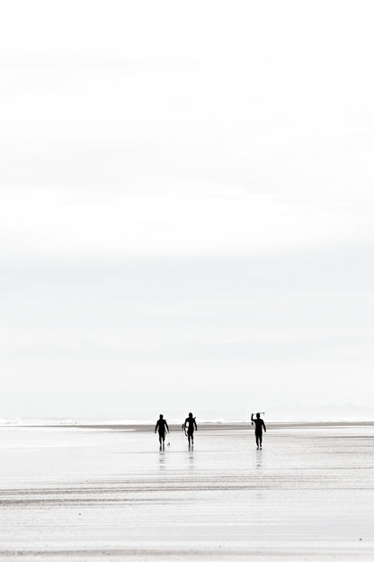 Surfers carrying surfboards on the sand at Black’s Beach, black and white, by Salt Creek Prints
