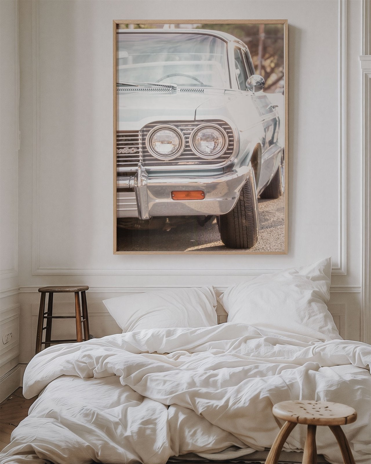 Framed photo of: Chevrolet 7975 displayed on a wall above a bed in a cozy bedroom.