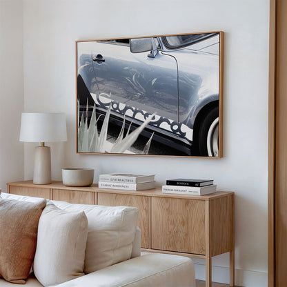 Framed canvas photo of: Porsche Carrera 8334 displayed on a wall above a couch in a neutral living room.
