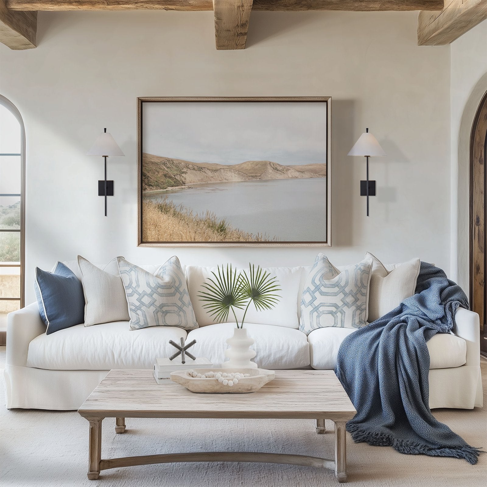 Framed photo of: Drakes Bay 7384 displayed above a couch in a coastal living room.