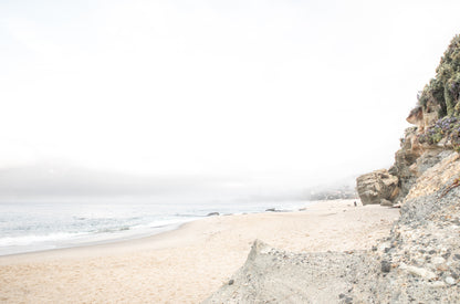 Photography by Kim Dybczak of: Laguna Beach cliffs rise above the shoreline, meeting open ocean below.